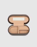 Open jewelry box with beige interior on a light gray background