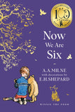 Book cover of 'Now We Are Six' by A.A. Milne with illustrations of a child and Pooh bear on a purple background.