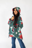 Woman wearing a floral-patterned raincoat on a green background
