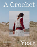 Book cover of 'A Crochet Year' with a person wearing a crocheted vest in a natural setting.
