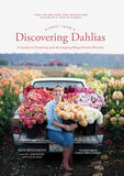 The image features the cover of the book 'Floret Farm's Discovering Dahlias' by Erin Benzakein. The cover shows a woman, Erin, sitting in front of a vibrant array of dahlias in various colors.