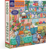 Jigsaw puzzle box featuring a colorful kitchen scene with various items and a cat.