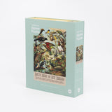 A 1000-piece jigsaw puzzle box featuring artwork of native birds of New Zealand. The box is predominantly teal in color with a image of a bird-filled forest on the cover.