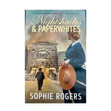 Book cover of 'Nightshades & Paperyhites' by Sophie Rogers with a woman and man walking in the background.