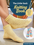 Book titled 'The Little Sock Knitting Book' with a person wearing yellow knitted socks and colorful yarn on a wooden floor.