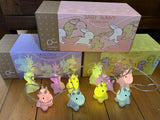 A string of fairy lights in the shape of pastel-colored baby animals, including unicorns, displayed in front of its packaging box.